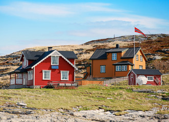 Norwegian village with colorful wooden houses on rocky sea coast