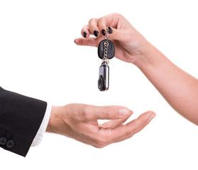 Fototapeta premium Female hand giving car key to male hand
