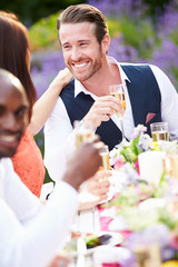 Group Of Friends Enjoying Outdoor Dinner Party