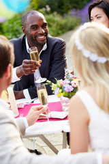 Friends Proposing Champagne Toast At Wedding