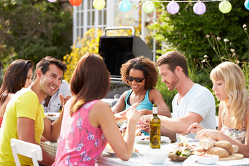 Group Of Friends Having Outdoor Barbeque At Home