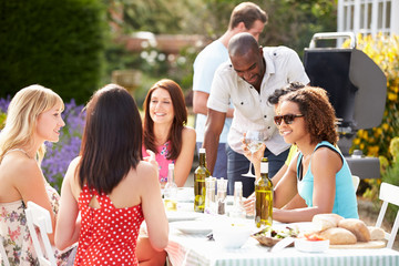 Group Of Friends Having Outdoor Barbeque At Home