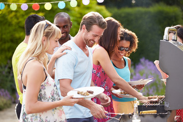 Group Of Friends Having Outdoor Barbeque At Home - obrazy, fototapety, plakaty