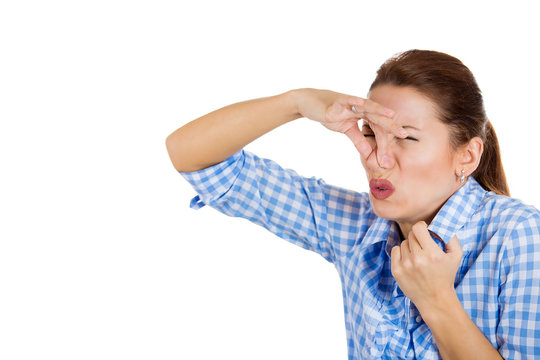 Woman covers her nose, can't breath, something stinks