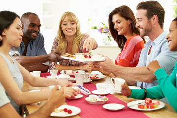 Group Of Friends Having Cheese And Coffee Dinner Party