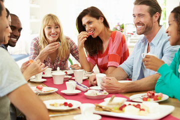 Group Of Friends Having Cheese And Coffee Dinner Party