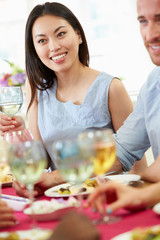 Young Couple Relaxing At Dinner Party