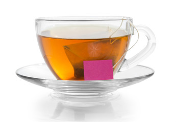 Transparent cup with tea on saucer