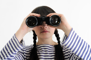 young female sailor looking through binoculars