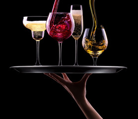 set with different drinks on black background