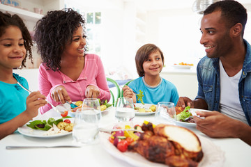 African American Family Eating Meal At Home Together