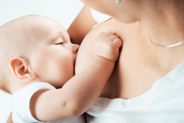 Obraz na płótnie Canvas Baby feeds on MOM's breasts