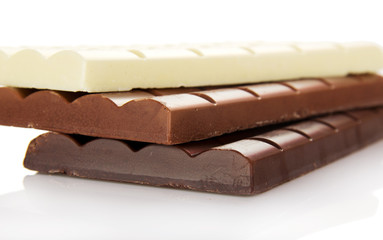 Stack of porous white, dark and milk chocolate