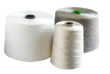 Linen and silk yarn bobbins isolated on white background