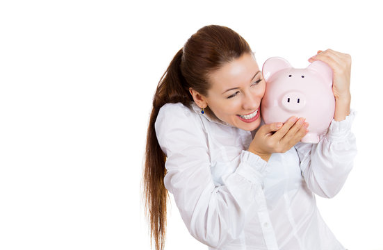 Excited young woman holding a piggy bank