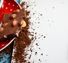 Dark chocolate on coffee plate and blank paper