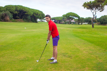 Young man playing golf