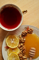 Honey with walnuts and lemon with cup of tea