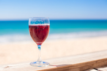 Glass of red wine background the turquoise sea
