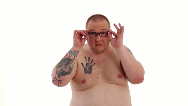 tattooed man styles himself 