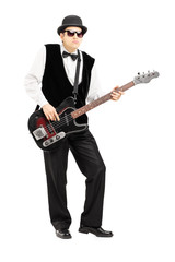 Obraz premium Full length portrait of a person playing a bass guitar