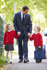 Father Walking To School With Children On Way To Work