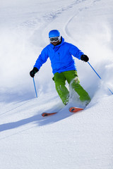 Fototapeta na wymiar Skiing, Skier, Freeride in fresh powder snow - man skiing downhi