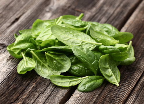 Spinach on a wooden background