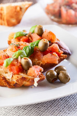 Bruschetta with mozzarella, tomato and olive