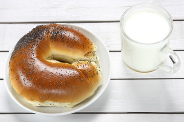 Croissant and milk on wooden table