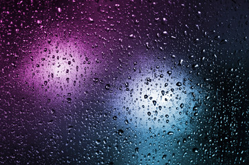 colored background of a glass with waterdrops