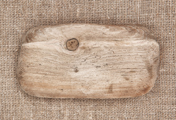 Piece of old wood on burlap background