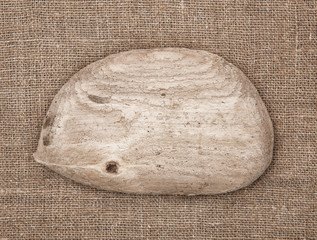 Piece of old wood on burlap background