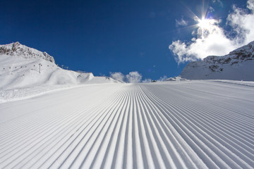 Fresh snow groomer tracks on a ski piste - obrazy, fototapety, plakaty