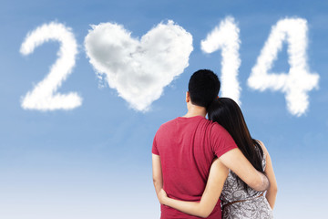 Couple looking at clouds shaped 2014