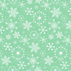 Seamless vector pattern - white snowflakes on green background
