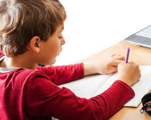 boy writing indoors