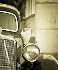 Old timer car with wedding decoration in sepia