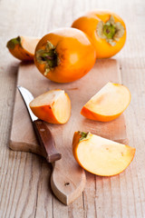 ripe persimmons and knife