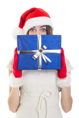 Surprised teenage girl wearing Santa beanie holding big giftbox