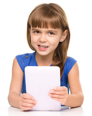 Young girl is using tablet