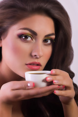 Beautiful woman with coffee cup. Fashion portrait