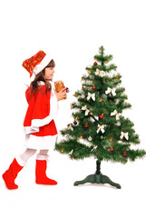 Little girl decorate a christmas tree