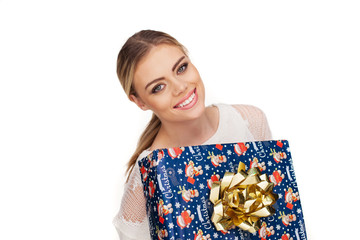 woman holds a gift wrapped in christmas paper