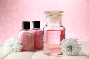 Obraz na płótnie Canvas Glass bottle with color essence, on pink background