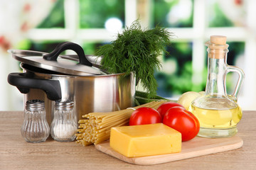 Ingredients for cooking pasta on table in kitchen