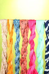 Naklejka premium Colored scarves on green background