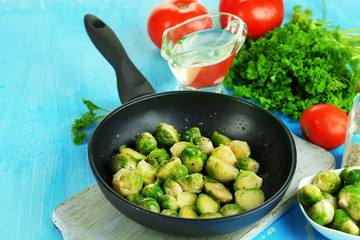 Fresh brussels sprouts in pan with vegetables and spices
