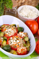 Stuffed tomatoes in bowl on wooden table close-up