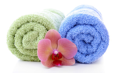Obraz na płótnie Canvas Orchid flower and towel rolls, isolated on white